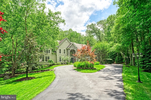 5026 Huntwood Manor Dr, Fairfax, VA 22030 - view of front of property featuring curved driveway, a front lawn, and stone siding