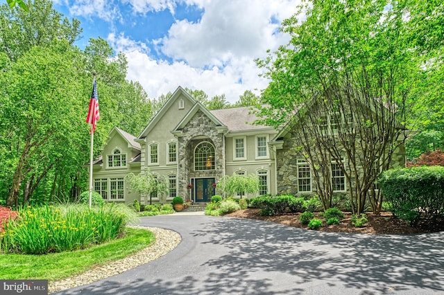 5026 Huntwood Manor Dr, Fairfax, VA 22030 - view of front of home featuring stone siding, stucco siding, and driveway