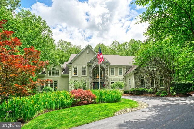 5026 Huntwood Manor Dr, Fairfax, VA 22030 - view of front of house featuring stone siding, stucco siding, and a front lawn