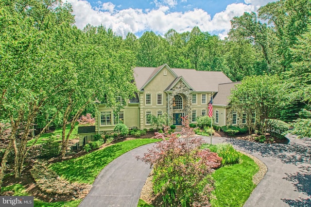 5026 Huntwood Manor Dr, Fairfax, VA 22030 - colonial inspired home featuring stone siding, stucco siding, and curved driveway