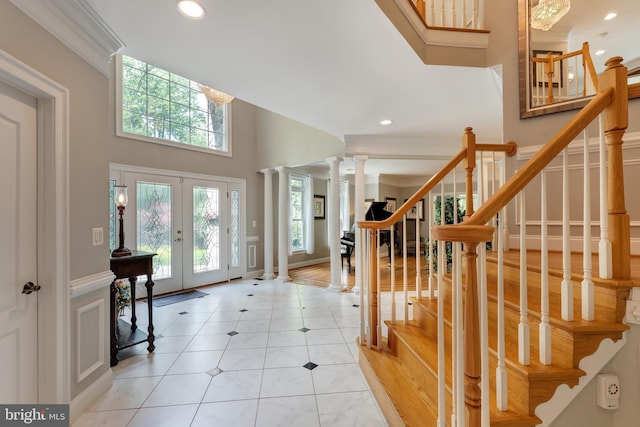 5026 Huntwood Manor Dr, Fairfax, VA 22030 - entrance foyer featuring french doors, recessed lighting, light tile patterned floors, decorative columns, and stairs