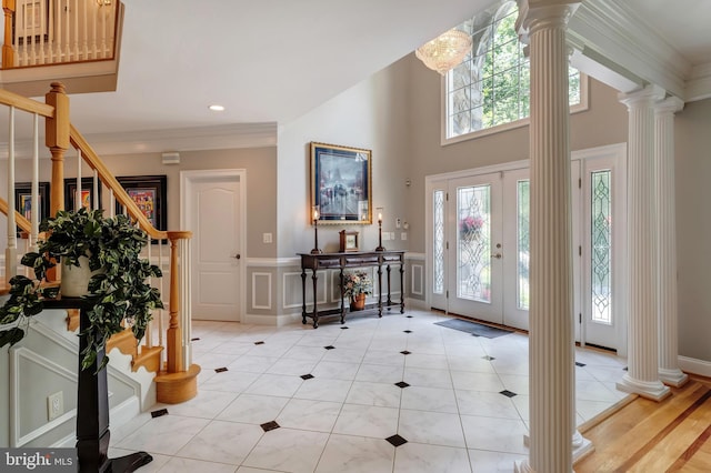 5026 Huntwood Manor Dr, Fairfax, VA 22030 - foyer featuring ornate columns, stairway, healthy amount of natural light, a decorative wall, and a wainscoted wall
