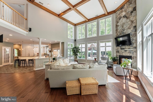 5026 Huntwood Manor Dr, Fairfax, VA 22030 - living room with healthy amount of natural light, a fireplace, dark wood finished floors, beam ceiling, and a towering ceiling