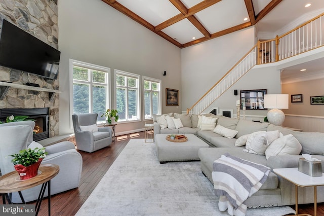 5026 Huntwood Manor Dr, Fairfax, VA 22030 - living room with a high ceiling, stairs, a stone fireplace, wood-type flooring, and beamed ceiling