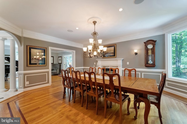 5026 Huntwood Manor Dr, Fairfax, VA 22030 - dining space featuring arched walkways, a chandelier, crown molding, a decorative wall, and wainscoting