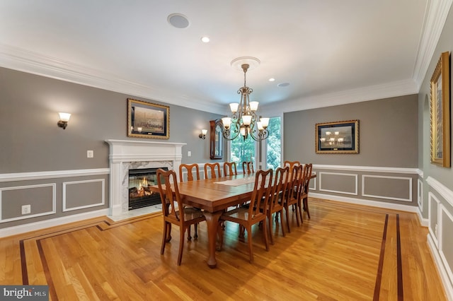 5026 Huntwood Manor Dr, Fairfax, VA 22030 - dining room with a chandelier, ornamental molding, a fireplace, light wood-style floors, and a decorative wall