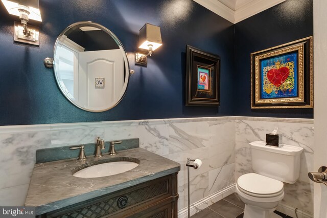 5026 Huntwood Manor Dr, Fairfax, VA 22030 - half bathroom with vanity, toilet, tile walls, wainscoting, and tile patterned flooring