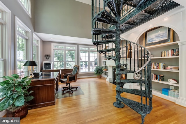 5026 Huntwood Manor Dr, Fairfax, VA 22030 - home office featuring wood finished floors, plenty of natural light, a high ceiling, and built in features