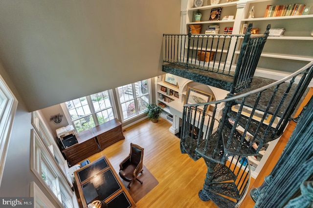 5026 Huntwood Manor Dr, Fairfax, VA 22030 - staircase featuring wood finished floors, healthy amount of natural light, a fireplace, and a towering ceiling