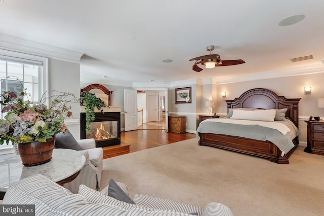 5026 Huntwood Manor Dr, Fairfax, VA 22030 - bedroom with ornamental molding, a multi sided fireplace, and wood finished floors