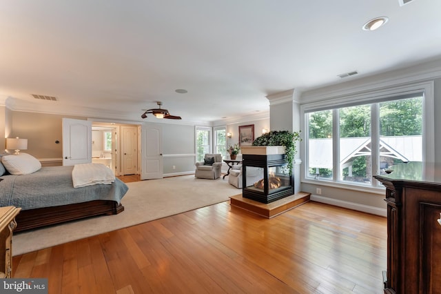 5026 Huntwood Manor Dr, Fairfax, VA 22030 - bedroom with light wood-style flooring, ornamental molding, a multi sided fireplace, and baseboards