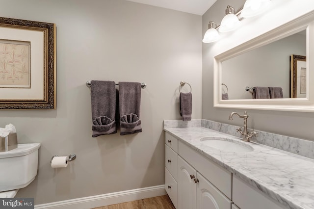 5026 Huntwood Manor Dr, Fairfax, VA 22030 - bathroom with toilet, vanity, baseboards, and wood finished floors