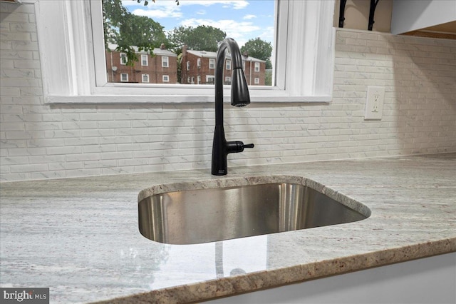 307 W 32nd St, Wilmington, DE 19802 - kitchen view of a sink, backsplash, and light stone countertops