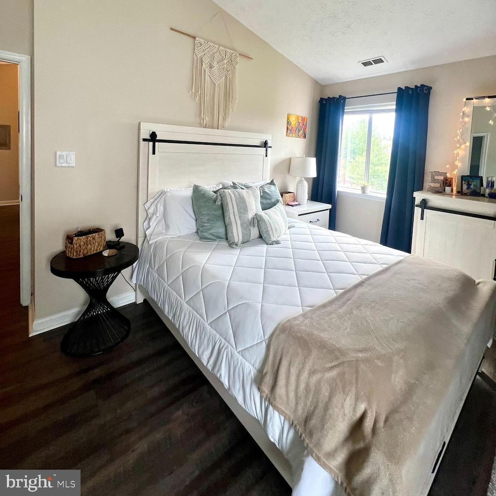 2125 Wainwright Ct Unit 2C, Frederick, MD 21702 - bedroom with wood finished floors, lofted ceiling, and a textured ceiling