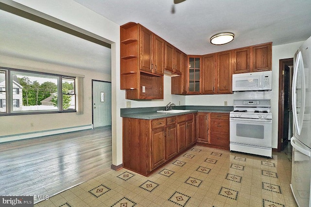 50 Nautilus Dr, Barnegat, NJ 08005 - kitchen featuring white appliances, a baseboard radiator, a sink, open shelves, and dark countertops