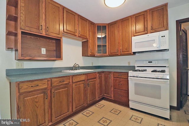 50 Nautilus Dr, Barnegat, NJ 08005 - kitchen with white appliances, a sink, brown cabinets, and glass insert cabinets