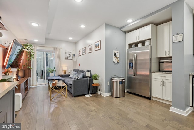 1843 N 6th St Unit 9, Philadelphia, PA 19122 - kitchen with stainless steel refrigerator with ice dispenser, light wood-style flooring, recessed lighting, white cabinets, and light countertops