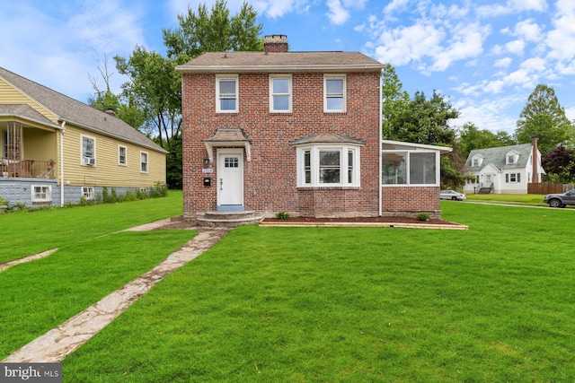 2318 Cloville Ave, Baltimore, MD 21214 - view of front of home featuring a chimney, brick siding, and a sunroom