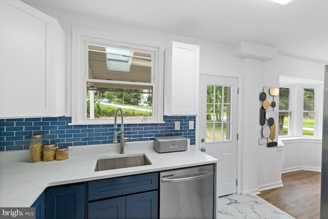 2318 Cloville Ave, Baltimore, MD 21214 - kitchen with dishwasher, a sink, decorative backsplash, white cabinetry, and light stone countertops