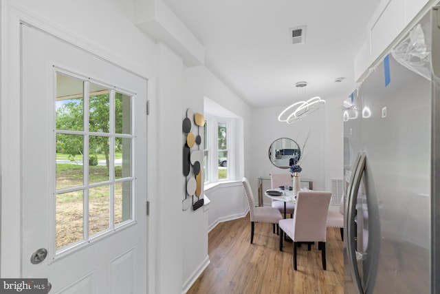 2318 Cloville Ave, Baltimore, MD 21214 - dining space with wood finished floors, baseboards, and a chandelier