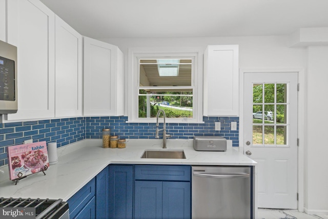 2318 Cloville Ave, Baltimore, MD 21214 - kitchen featuring stainless steel dishwasher, a sink, and white cabinetry