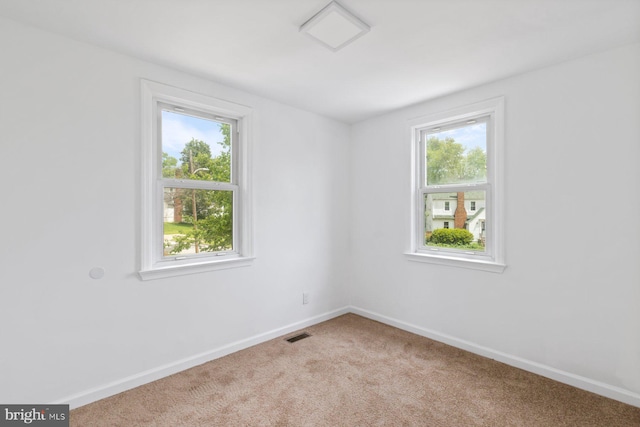 2318 Cloville Ave, Baltimore, MD 21214 - carpeted spare room featuring plenty of natural light and baseboards