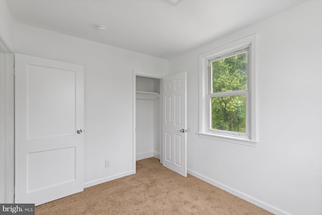 2318 Cloville Ave, Baltimore, MD 21214 - unfurnished bedroom with light colored carpet, baseboards, and a closet