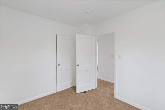 2318 Cloville Ave, Baltimore, MD 21214 - unfurnished bedroom featuring light colored carpet and baseboards