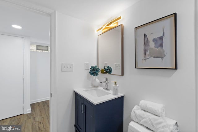 2318 Cloville Ave, Baltimore, MD 21214 - bathroom with vanity, wood finished floors, toilet, and recessed lighting