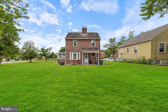 2318 Cloville Ave, Baltimore, MD 21214 - back of property featuring a chimney, brick siding, and a yard