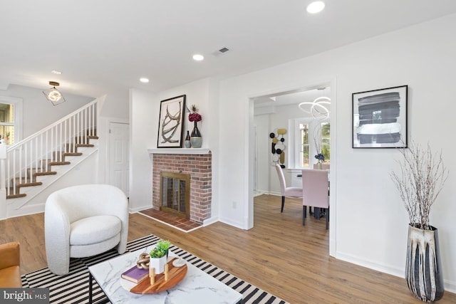 2318 Cloville Ave, Baltimore, MD 21214 - living room with stairs, healthy amount of natural light, wood finished floors, a fireplace, and recessed lighting