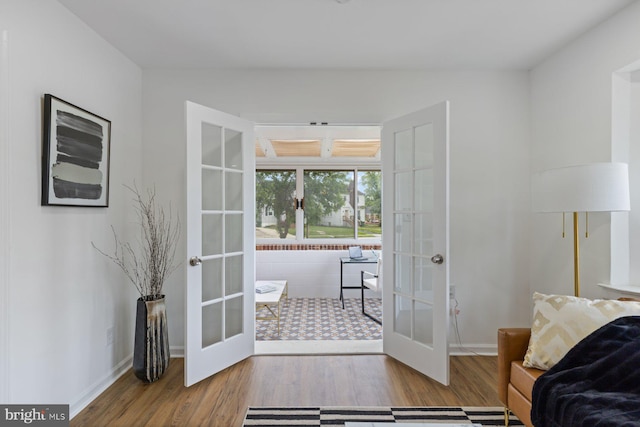 2318 Cloville Ave, Baltimore, MD 21214 - living area with french doors, wood finished floors, and baseboards