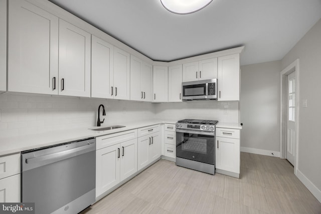 2831 Goucher Ave, Delanco, NJ 08075 - kitchen with appliances with stainless steel finishes, a sink, light countertops, backsplash, and white cabinets