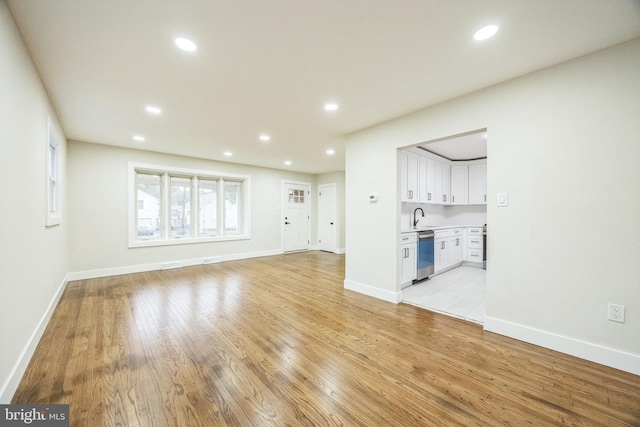 2831 Goucher Ave, Delanco, NJ 08075 - unfurnished living room with light wood finished floors, recessed lighting, baseboards, and a sink
