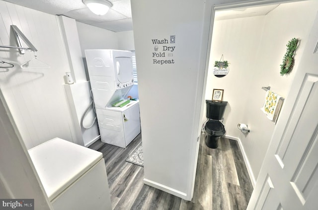 310 E S St, York, PA 17403 - laundry room with stacked washer and clothes dryer, wood finished floors, and baseboards