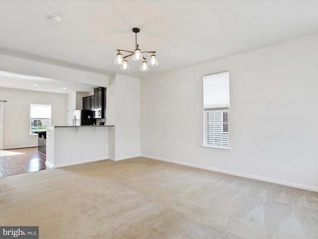 100 Norwood Dr, Falling Waters, WV 25419 - unfurnished living room with a chandelier, light carpet, baseboards, and recessed lighting