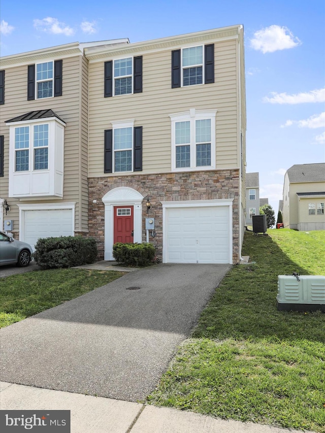 100 Norwood Dr, Falling Waters, WV 25419 - view of property with an attached garage, central air condition unit, driveway, stone siding, and a front yard