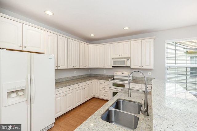 3839 Mulberry Point Ct, Dumfries, VA 22025 - kitchen featuring white appliances, a sink, recessed lighting, light stone countertops, and white cabinetry