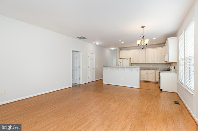 3839 Mulberry Point Ct, Dumfries, VA 22025 - kitchen with a chandelier, range, light wood-style flooring, healthy amount of natural light, and recessed lighting
