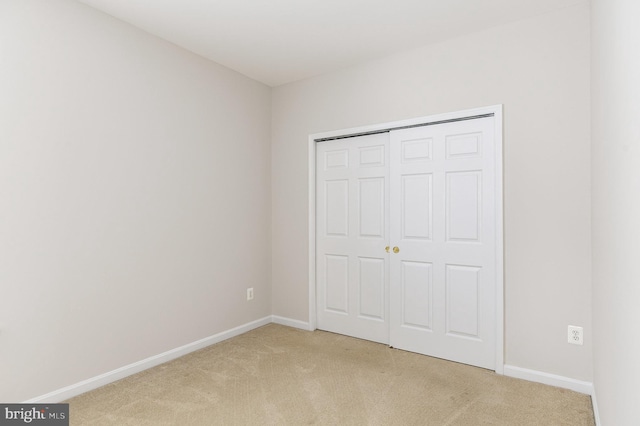 3839 Mulberry Point Ct, Dumfries, VA 22025 - unfurnished bedroom featuring light carpet, baseboards, and a closet