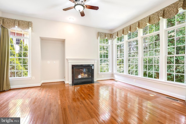 3530 Schuerman House Dr, Fairfax, VA 22031 - unfurnished living room featuring wood-type flooring, baseboards, a ceiling fan, and healthy amount of natural light