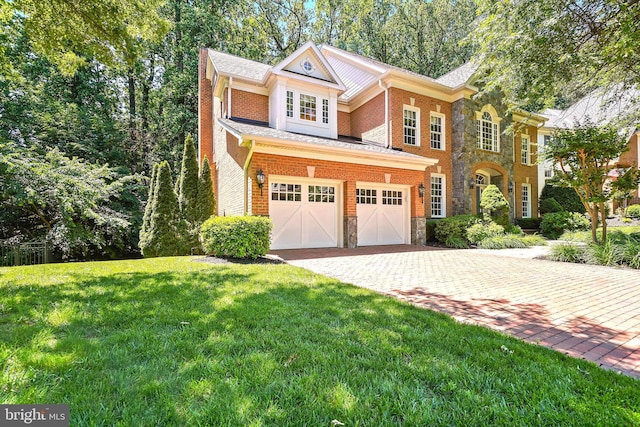 3530 Schuerman House Dr, Fairfax, VA 22031 - view of front facade with a front yard, stone siding, driveway, and a garage