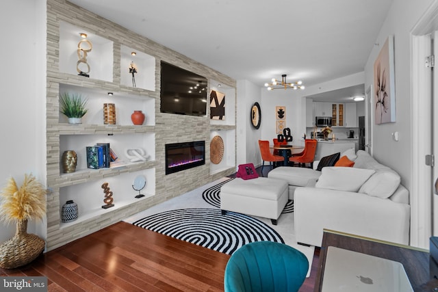 155 Potomac Psge Unit 809, Oxon Hill, MD 20745 - living area featuring a chandelier, wood finished floors, and a glass covered fireplace