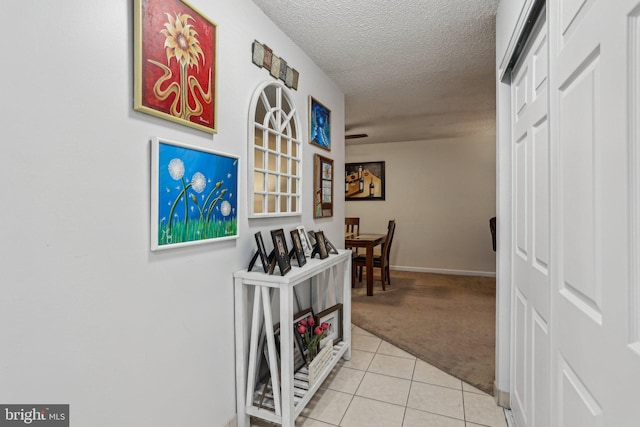 700 Avondale Rd Unit Ph-12, Wallingford, PA 19086 - hallway featuring light colored carpet, light tile patterned flooring, a textured ceiling, and baseboards
