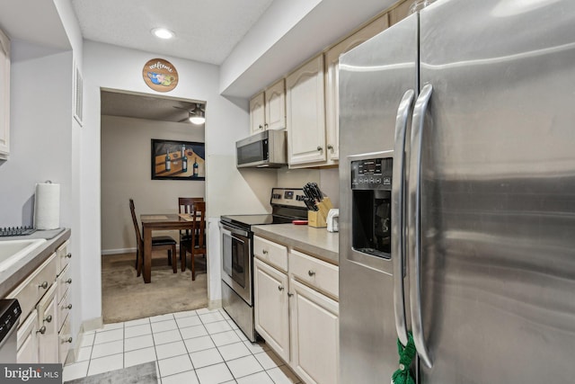 700 Avondale Rd Unit Ph-12, Wallingford, PA 19086 - kitchen featuring stainless steel appliances, light carpet, light tile patterned floors, baseboards, and light countertops