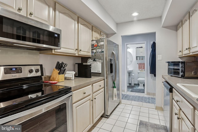 700 Avondale Rd Unit Ph-12, Wallingford, PA 19086 - kitchen featuring stainless steel appliances, light countertops, light tile patterned floors, and recessed lighting