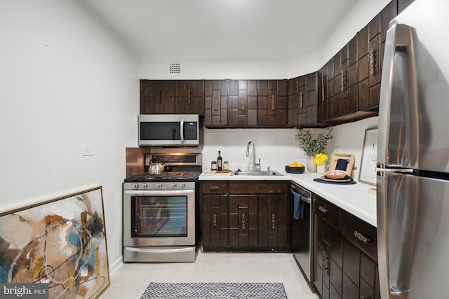 700 7th St SW Unit 512, Washington, DC 20024 - kitchen featuring appliances with stainless steel finishes, a sink, light countertops, and dark brown cabinetry