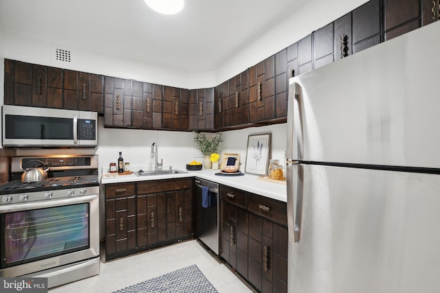 700 7th St SW Unit 512, Washington, DC 20024 - kitchen featuring stainless steel appliances, a sink, light countertops, and dark brown cabinetry
