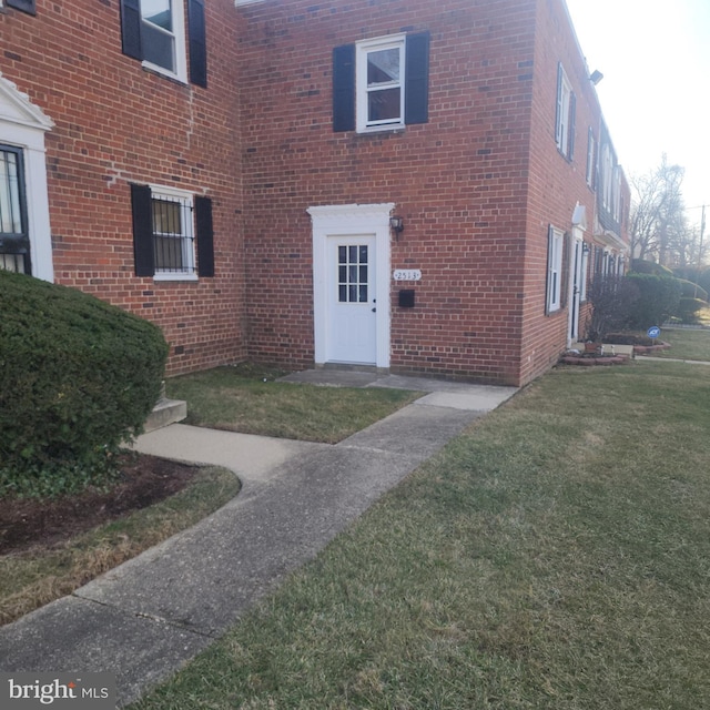 2513 Iverson St, Temple Hills, MD 20748 - view of exterior entry featuring brick siding and a lawn