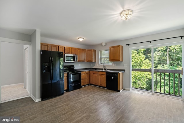 430 Cedar Creek Dr, Harpers Ferry, WV 25425 - kitchen featuring black appliances, baseboards, a sink, dark wood finished floors, and dark countertops